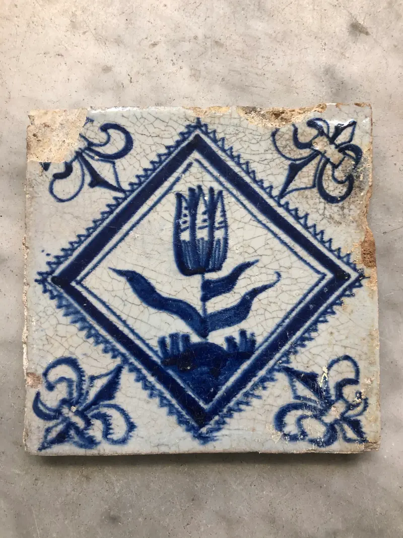17 th century delft tile with tulip in diamond