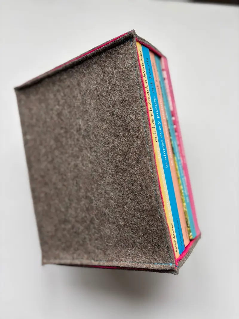 In almost every picture. The first five volumes of this series, together in a cloth slipcase.